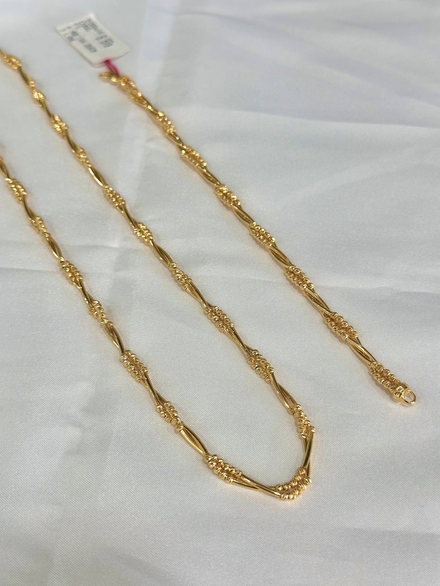 "Gold chain on a white background"