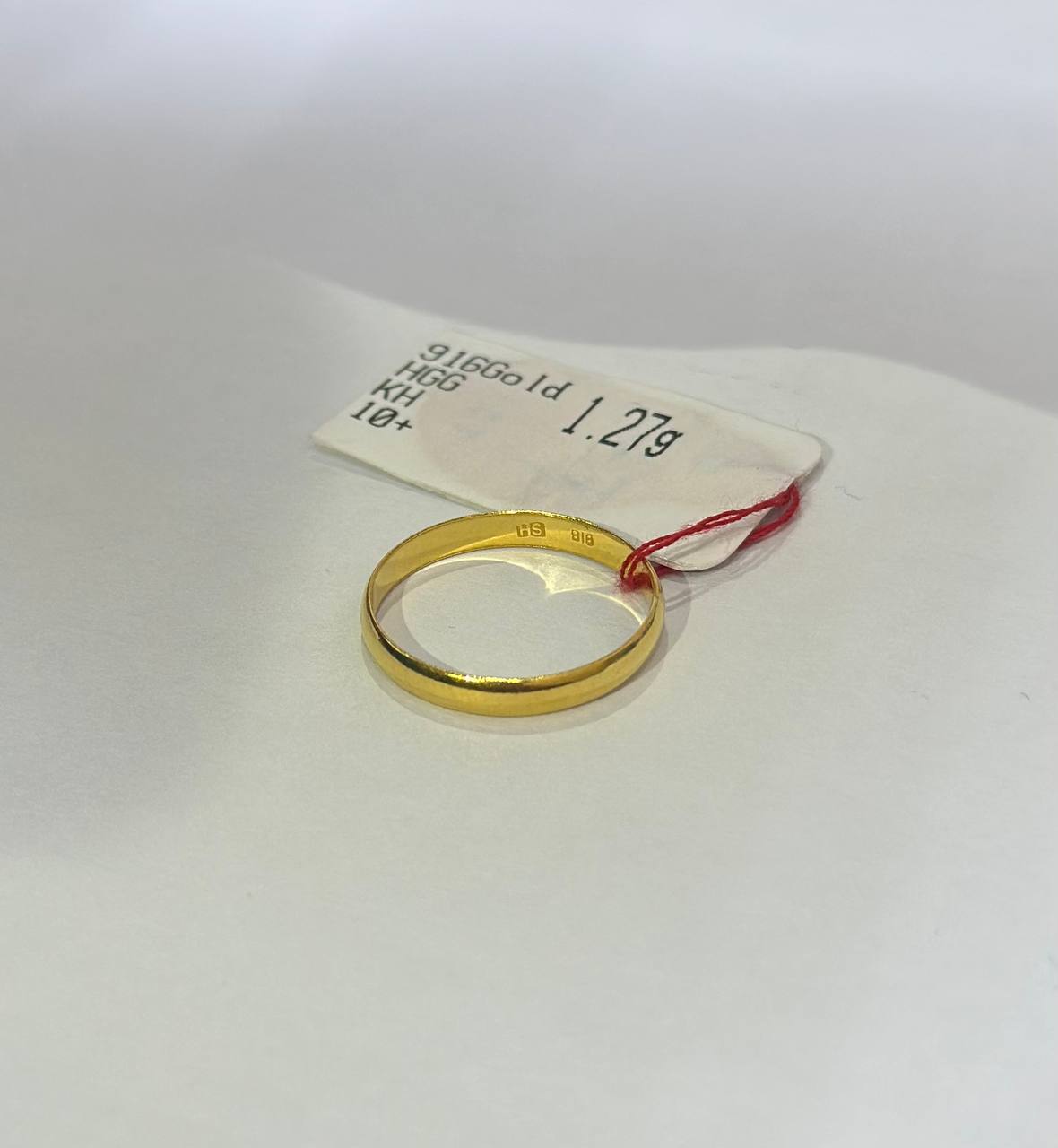 "Plain design 916 gold ring with a tag on a white background"