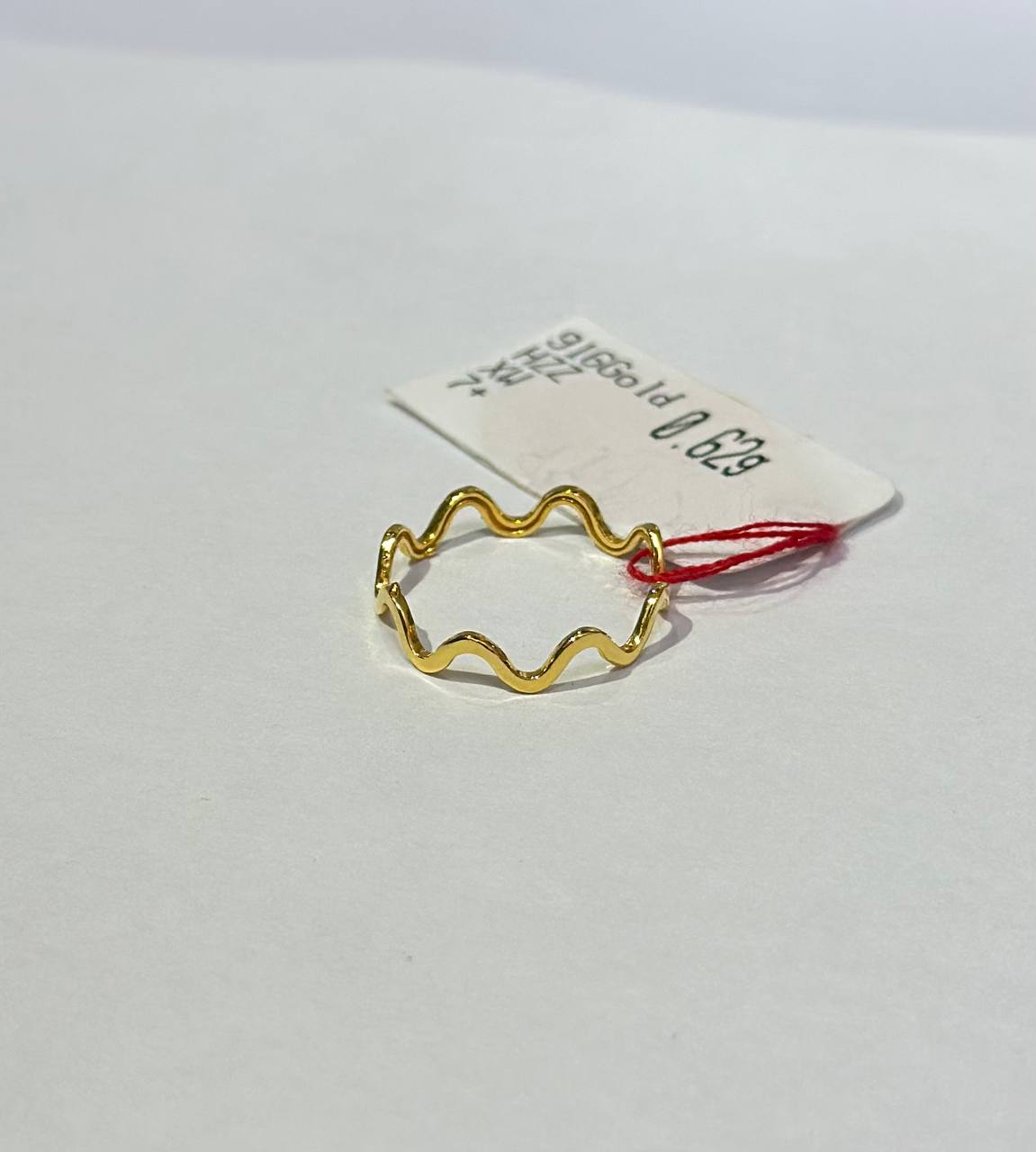 "wave design 916 gold ring with a wavy design on a white background"