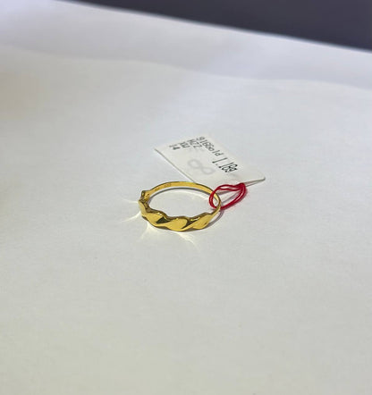 "Gold hoop mobius ring on a white card with text"