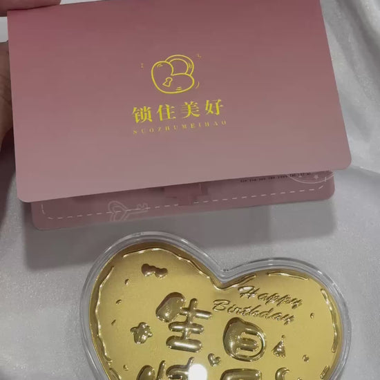 "Love shape 999 gold with a birthday card on white background"