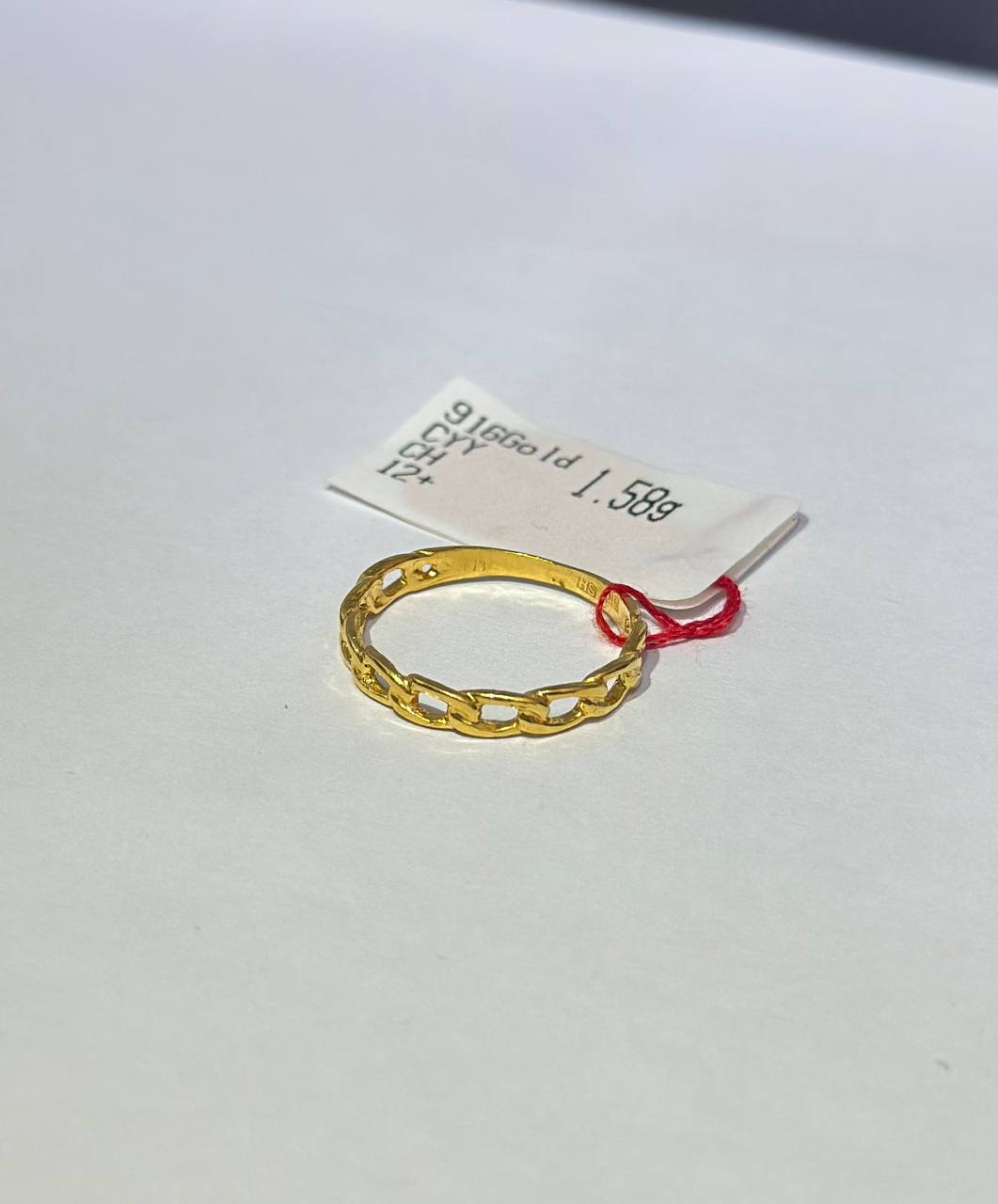 "Gold ring on a white background with a label"